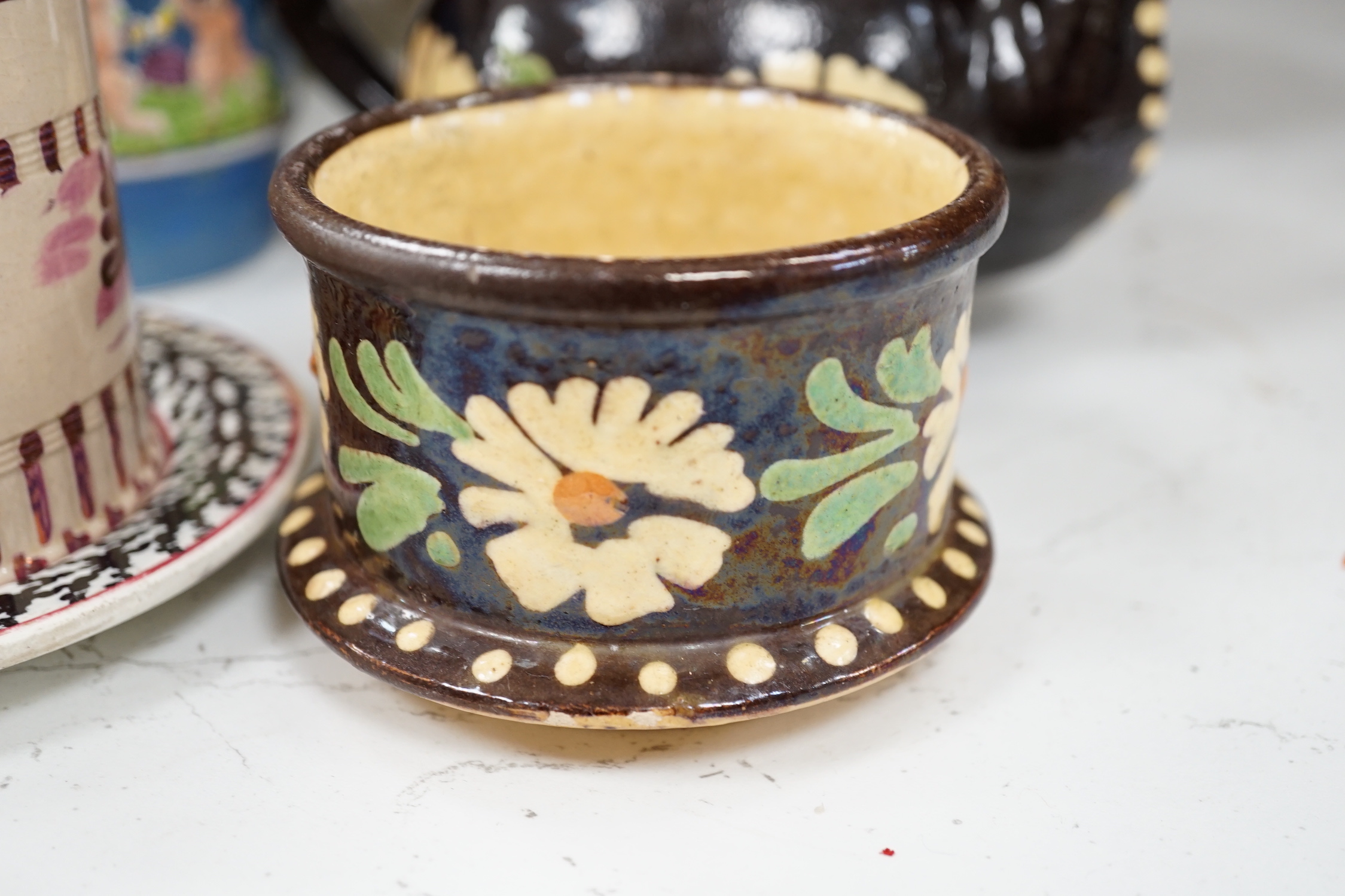 Two Pratt type jugs, an Enoch Wood flower pot, various 19th century pottery jugs, plates etc.